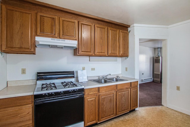 707 Maple St, Big Rapids, MI 49307 - kitchen with under cabinet range hood, range with gas stovetop, a sink, and brown cabinetry