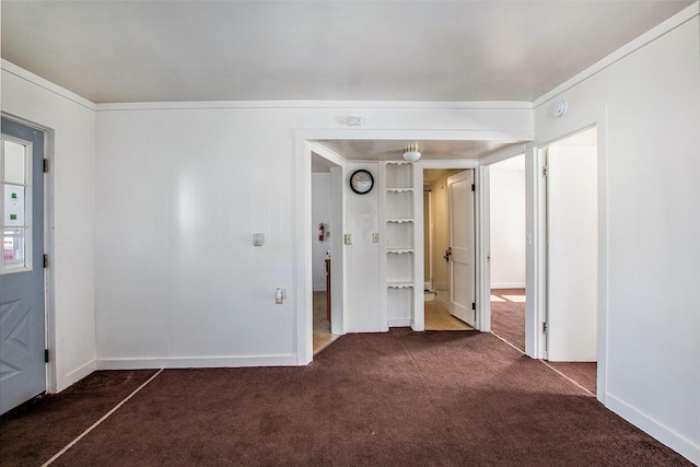 707 Maple St, Big Rapids, MI 49307 - unfurnished bedroom with dark carpet and baseboards