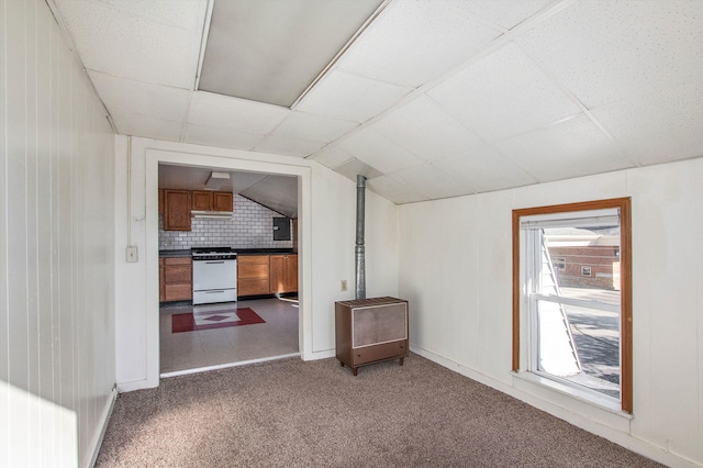 707 Maple St, Big Rapids, MI 49307 - empty room featuring dark colored carpet, lofted ceiling, and baseboards