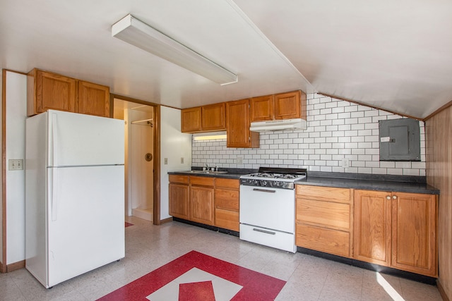 707 Maple St, Big Rapids, MI 49307 - kitchen with white appliances, under cabinet range hood, electric panel, dark countertops, and lofted ceiling