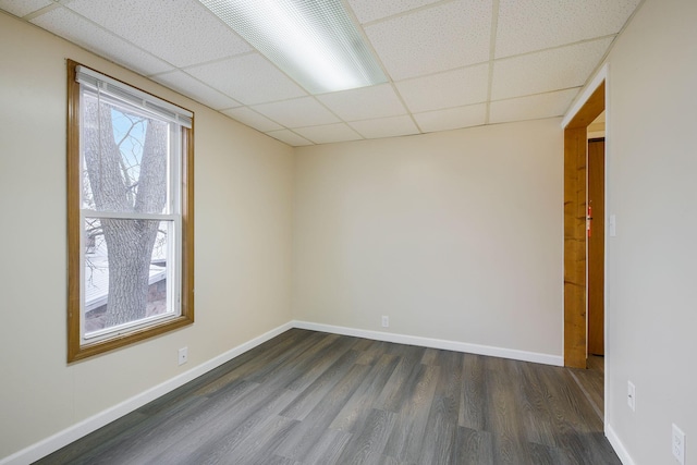 707 Maple St, Big Rapids, MI 49307 - unfurnished room featuring a paneled ceiling, dark wood-style floors, and baseboards