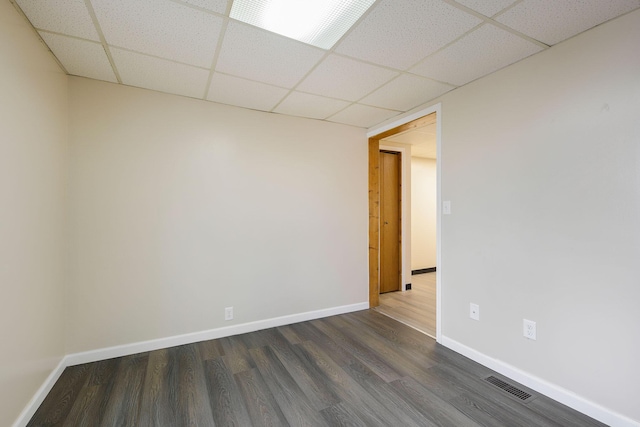 707 Maple St, Big Rapids, MI 49307 - empty room featuring a paneled ceiling, dark wood-style flooring, and baseboards