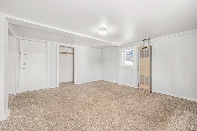 707 Maple St, Big Rapids, MI 49307 - unfurnished bedroom featuring a heating unit, carpet flooring, and a closet