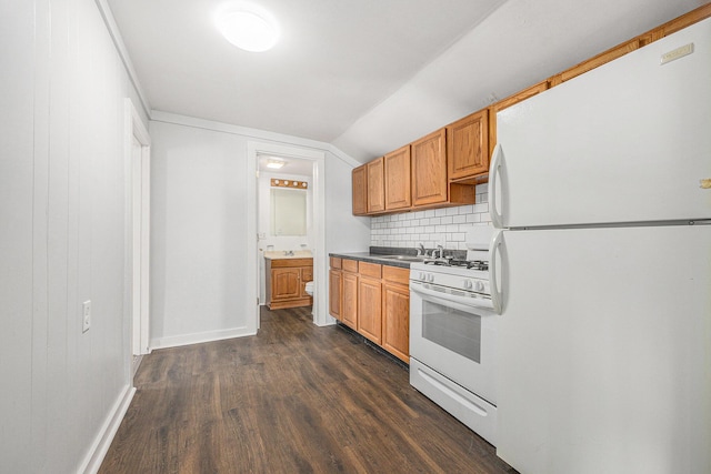 707 Maple St, Big Rapids, MI 49307 - kitchen with white appliances, dark wood-style flooring, backsplash, lofted ceiling, and baseboards
