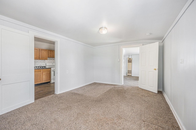 707 Maple St, Big Rapids, MI 49307 - spare room featuring dark carpet, baseboards, and a sink