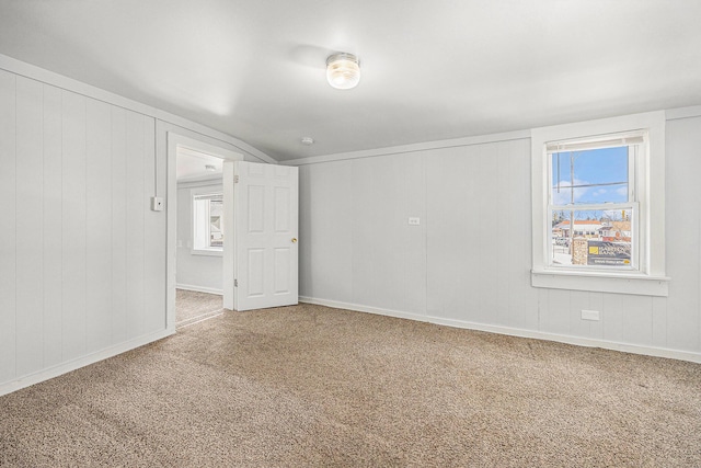 707 Maple St, Big Rapids, MI 49307 - spare room with carpet, vaulted ceiling, and baseboards