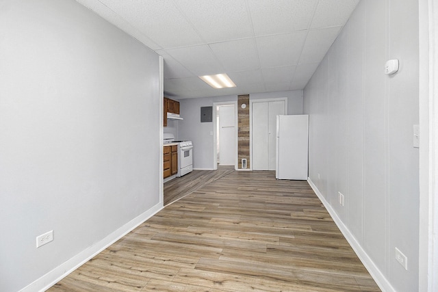707 Maple St, Big Rapids, MI 49307 - unfurnished living room with wood finished floors, baseboards, and electric panel