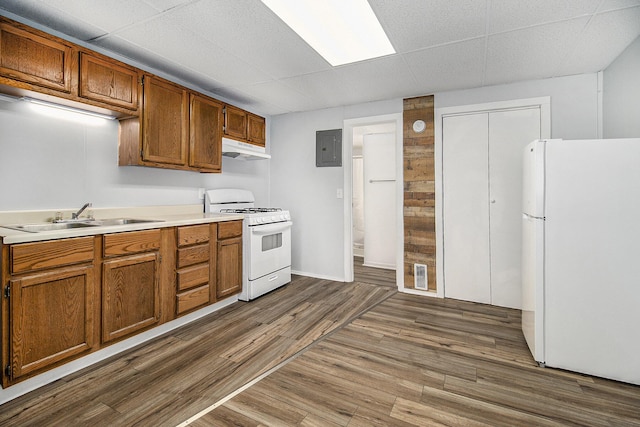 707 Maple St, Big Rapids, MI 49307 - kitchen featuring white appliances, a sink, under cabinet range hood, electric panel, and light countertops