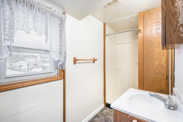 707 Maple St, Big Rapids, MI 49307 - full bathroom with a shower, vanity, and baseboards