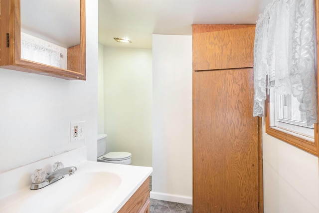 707 Maple St, Big Rapids, MI 49307 - bathroom featuring toilet, vanity, and baseboards