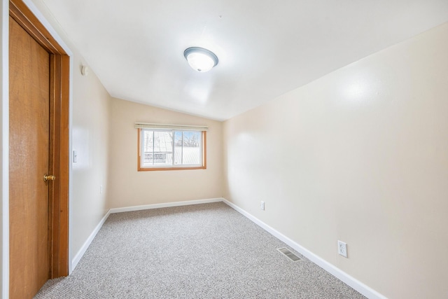 707 Maple St, Big Rapids, MI 49307 - empty room with carpet flooring, vaulted ceiling, and baseboards