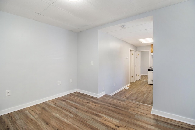 707 Maple St, Big Rapids, MI 49307 - empty room with light wood-style floors, baseboards, and a smoke detector