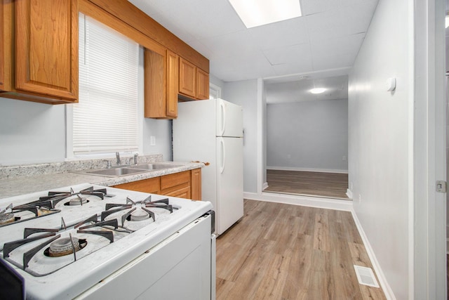 707 Maple St, Big Rapids, MI 49307 - kitchen featuring range, a sink, freestanding refrigerator, light countertops, and light wood-type flooring