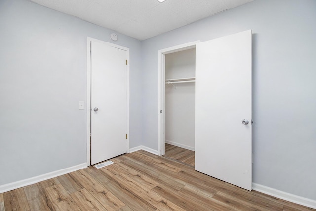 707 Maple St, Big Rapids, MI 49307 - unfurnished bedroom featuring light wood-style flooring, baseboards, and a closet