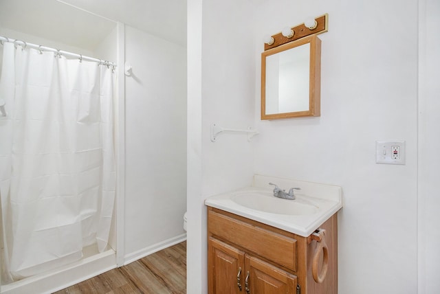 707 Maple St, Big Rapids, MI 49307 - full bathroom with wood finished floors, vanity, toilet, curtained shower, and baseboards