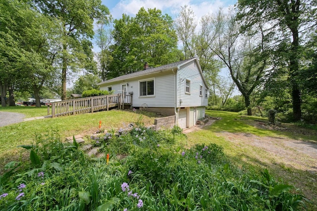 311 Rosehill Rd, Jackson, MI 49202 - view of front of house featuring a garage, a deck, a chimney, and a front yard