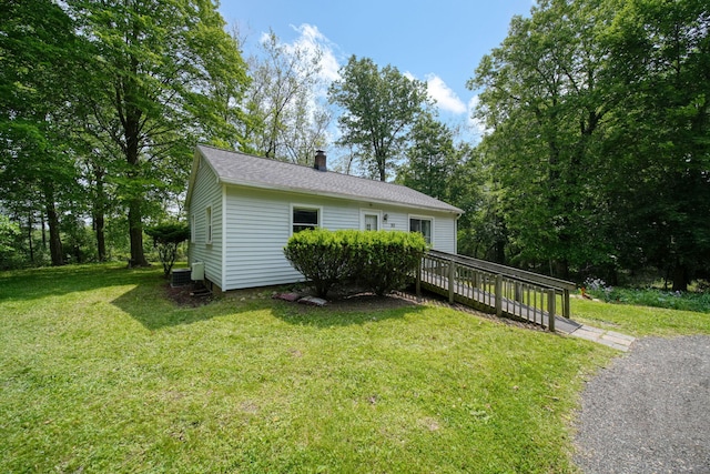 311 Rosehill Rd, Jackson, MI 49202 - view of front of property featuring a wooden deck, a chimney, and a front yard
