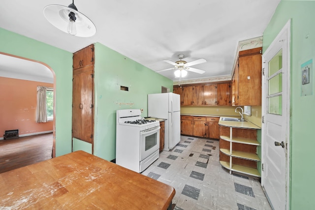 311 Rosehill Rd, Jackson, MI 49202 - kitchen featuring white appliances, a sink, brown cabinets, ceiling fan, and light countertops