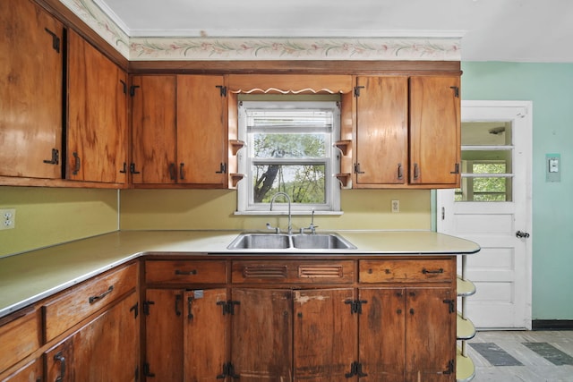 311 Rosehill Rd, Jackson, MI 49202 - kitchen featuring a sink, light countertops, plenty of natural light, and brown cabinets
