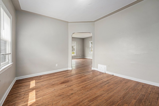 510 Woodlawn St SE, Grand Rapids, MI 49507 - spare room featuring arched walkways, wood finished floors, and baseboards