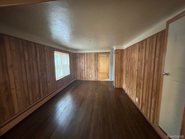 18821 Dalby, Redford, MI 48240 - unfurnished room with wooden walls, dark wood finished floors, and baseboard heating