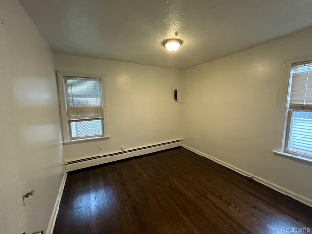 18821 Dalby, Redford, MI 48240 - empty room with a baseboard heating unit, baseboards, and dark wood-type flooring