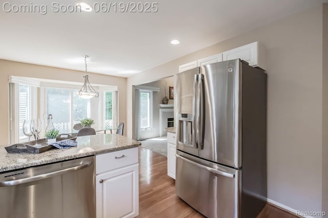 43221 Pointe Dr Unit 57, Clinton Township, MI 48038 - kitchen featuring appliances with stainless steel finishes, white cabinets, light stone countertops, and recessed lighting
