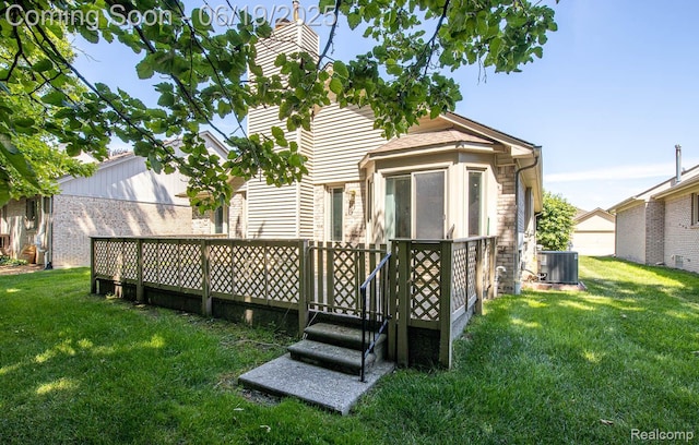 43221 Pointe Dr Unit 57, Clinton Township, MI 48038 - back of property featuring a lawn, a wooden deck, a chimney, and brick siding