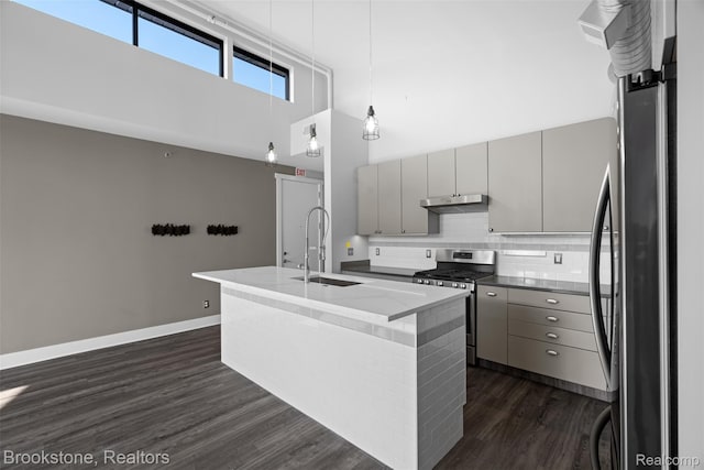 1711 Livernois St Unit 7, Ferndale, MI 48220 - kitchen with appliances with stainless steel finishes, gray cabinets, under cabinet range hood, a high ceiling, and a sink