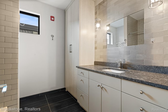 1711 Livernois St Unit 7, Ferndale, MI 48220 - full bathroom featuring vanity, tile patterned flooring, tasteful backsplash, and a shower