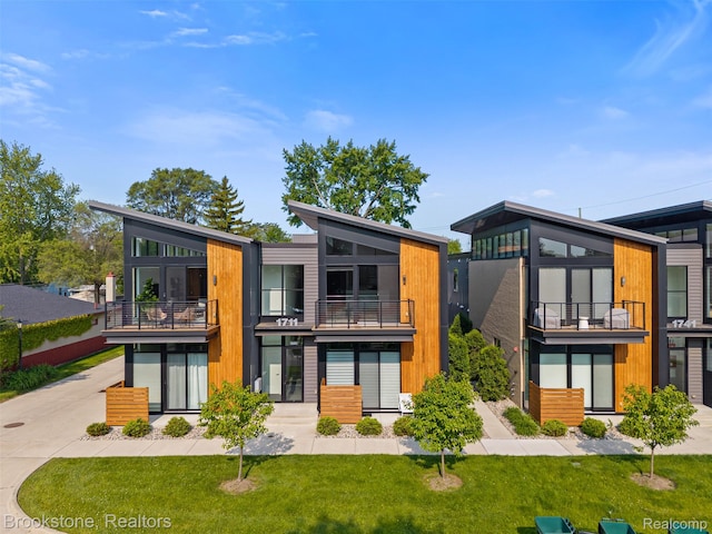 1711 Livernois St Unit 7, Ferndale, MI 48220 - rear view of property with a balcony, a lawn, and driveway