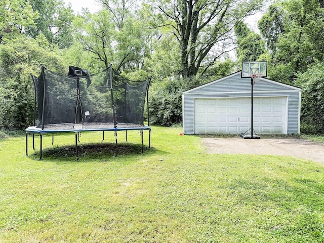 19549 Melrose Ave, Southfield, MI 48075 - view of green lawn featuring a trampoline, an outbuilding, a detached garage, and view of scattered trees