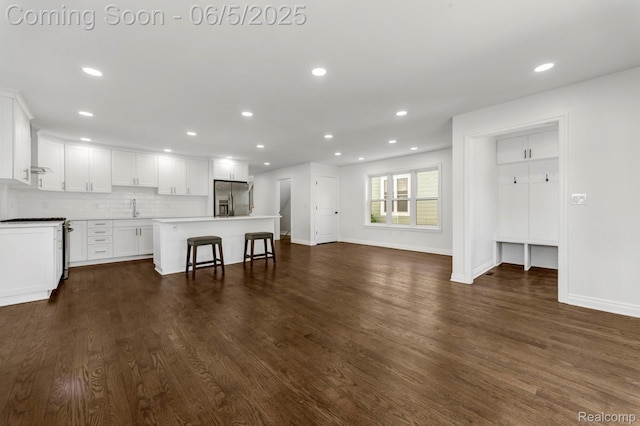 1285 Ruffner Ave, Birmingham, MI 48009 - unfurnished living room with recessed lighting, dark wood-type flooring, baseboards, and a sink