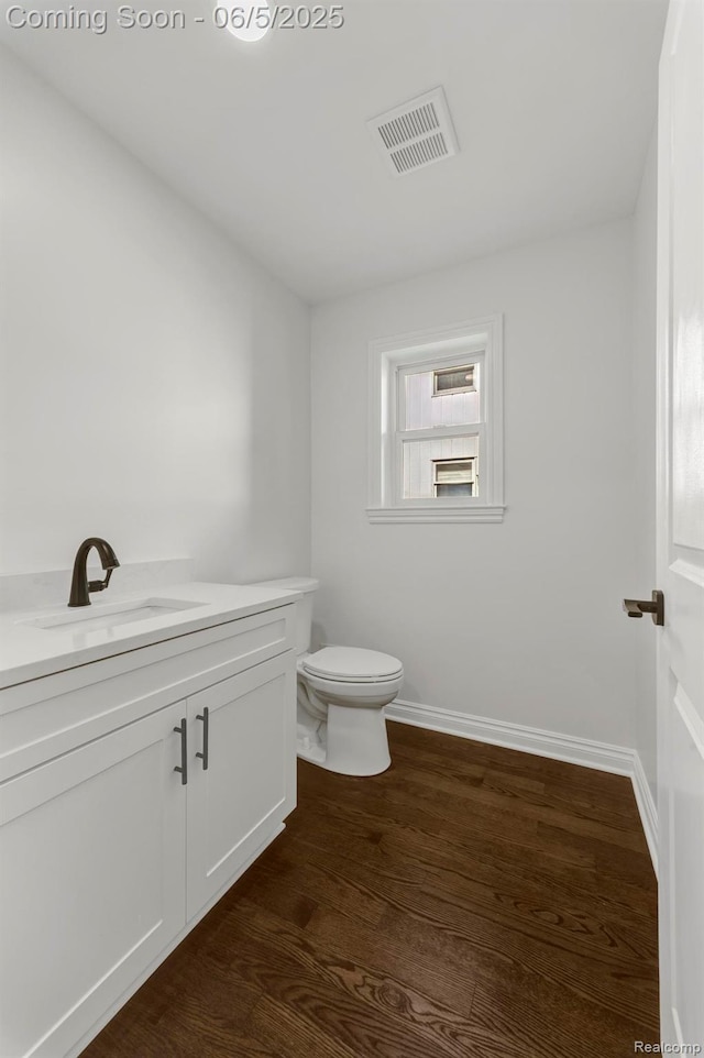 1285 Ruffner Ave, Birmingham, MI 48009 - bathroom with vanity, toilet, wood finished floors, and baseboards