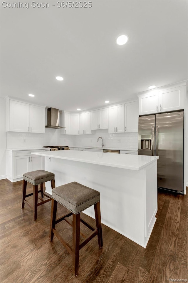 1285 Ruffner Ave, Birmingham, MI 48009 - kitchen featuring stainless steel fridge with ice dispenser, wall chimney exhaust hood, white cabinets, a kitchen breakfast bar, and light countertops