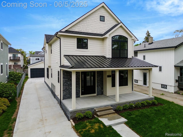 1285 Ruffner Ave, Birmingham, MI 48009 - modern farmhouse style home featuring a porch, an outbuilding, a detached garage, stone siding, and a front lawn