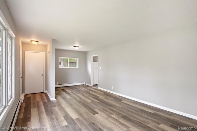 26315 Lehner St, Roseville, MI 48066 - spare room with a baseboard heating unit, wood finished floors, and baseboards