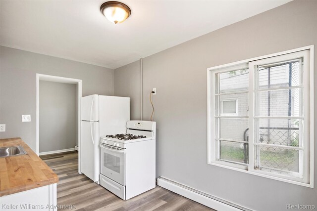 26315 Lehner St, Roseville, MI 48066 - kitchen with white appliances, light wood-style flooring, wooden counters, a baseboard heating unit, and baseboards