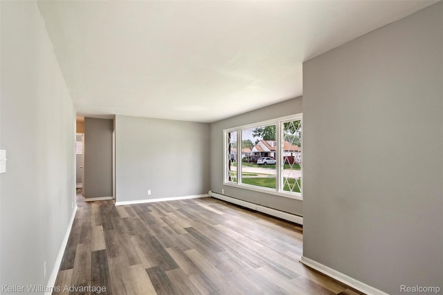 26315 Lehner St, Roseville, MI 48066 - unfurnished room with baseboard heating, dark wood-type flooring, and baseboards