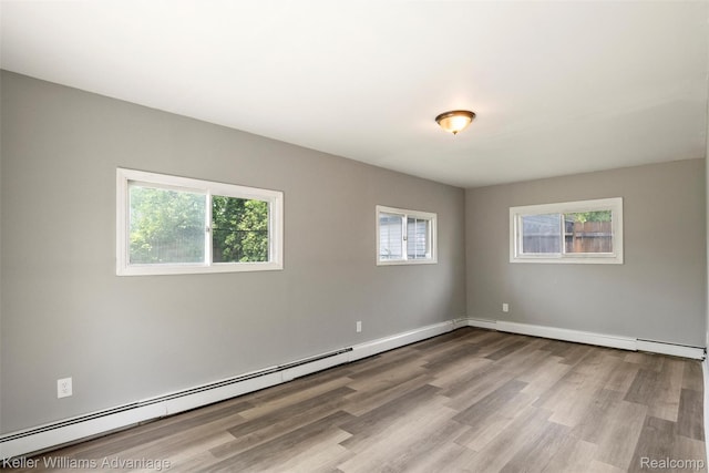 26315 Lehner St, Roseville, MI 48066 - unfurnished room featuring wood finished floors, a baseboard heating unit, and baseboards