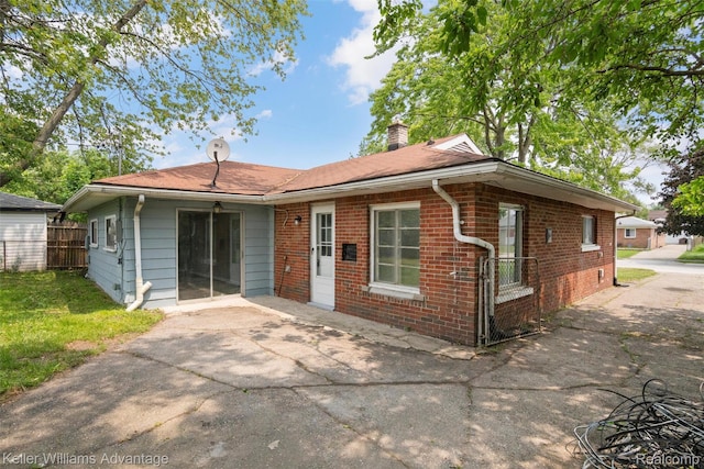26315 Lehner St, Roseville, MI 48066 - view of front facade with a chimney, brick siding, and a patio area