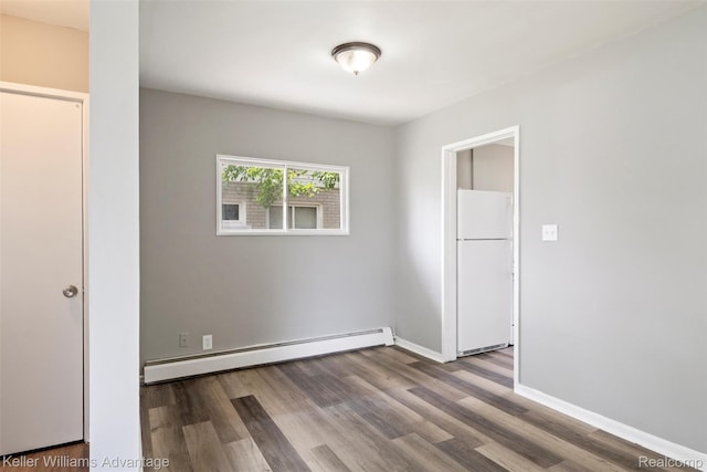 26315 Lehner St, Roseville, MI 48066 - spare room featuring baseboard heating, wood finished floors, and baseboards