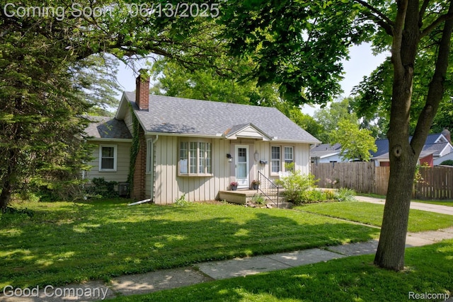 585 Roth Blvd, Clawson, MI 48017 - view of front of property featuring board and batten siding, a chimney, and a shingled roof