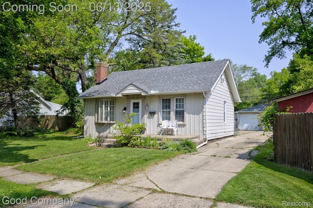 585 Roth Blvd, Clawson, MI 48017 - bungalow-style house featuring a chimney, an outdoor structure, and a shingled roof