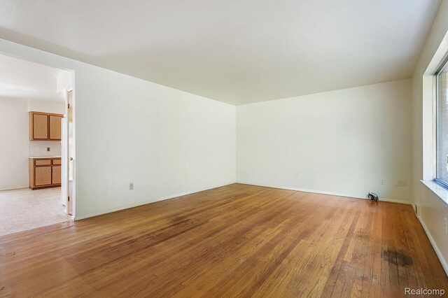 1312 N Bielby St, Waterford, MI 48328 - spare room featuring light wood-style flooring and baseboards