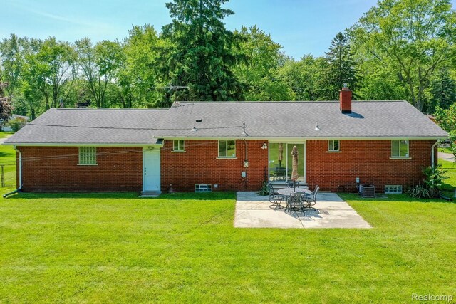 1312 N Bielby St, Waterford, MI 48328 - back of house with a patio area, central AC, a lawn, and a shingled roof