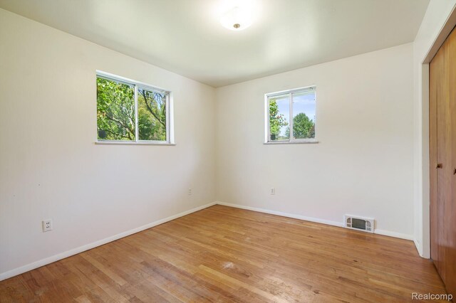 1312 N Bielby St, Waterford, MI 48328 - unfurnished bedroom with multiple windows, a closet, light wood-type flooring, and baseboards