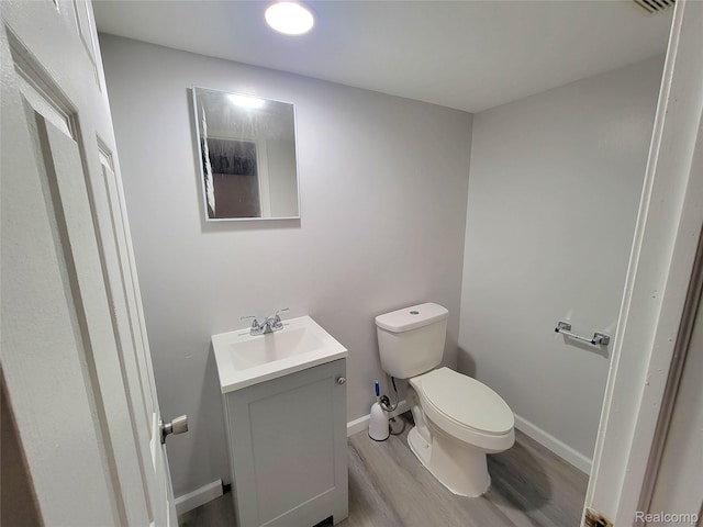 11618 Highland Dr, Warren, MI 48089 - bathroom with vanity, wood finished floors, toilet, and baseboards
