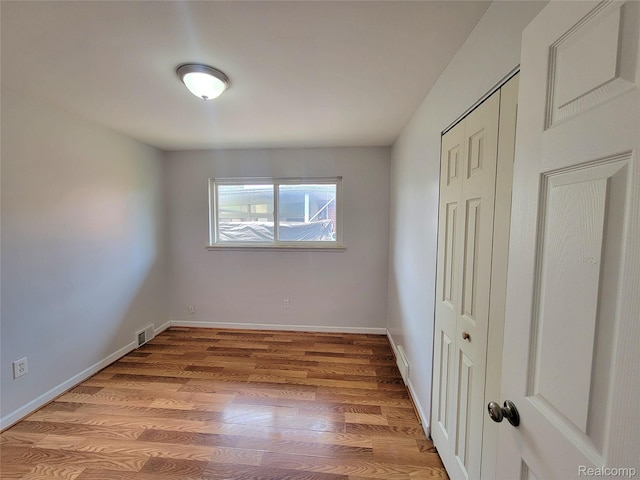 11618 Highland Dr, Warren, MI 48089 - unfurnished bedroom featuring light wood-style floors, a closet, and baseboards