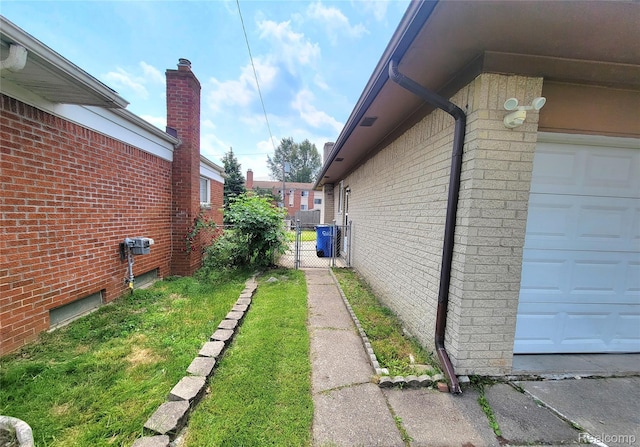 11618 Highland Dr, Warren, MI 48089 - view of home's exterior with a garage, brick siding, and a chimney
